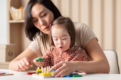 A child with down syndrome playing with her mother who is navigating through a divorce.