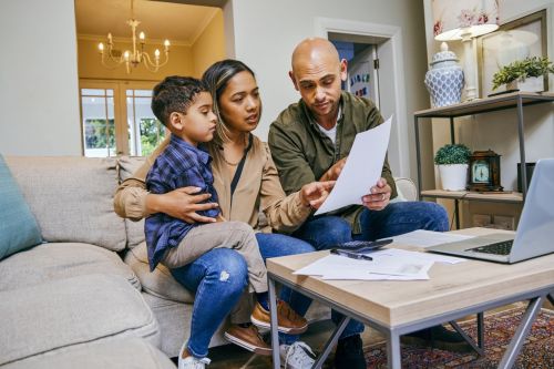 Shot of a young couple reviewing their finances while using their laptop - parenting plan concept.