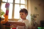 Little boy playing with a building blocks